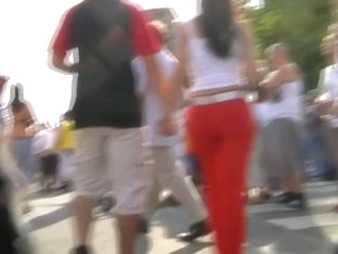 Sizzling brunette wearing bright red pants public street candid vid