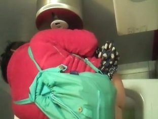 Woman in red jacket pissing