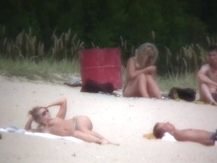 Nude couples are relaxing on a nudist beach here