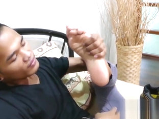 Good looking Asian twink shows his feet and strokes hard