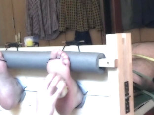 Naked bear tickled in stocks and on a rack