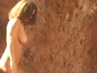 Cute youthful brunette hair disrobes by the water and goes slim dipping