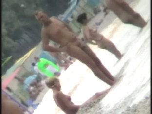 Voyeur view of fun in the water on a nudist beach