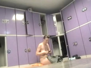 Naked Female Is Sitting On The Changing Room Bench