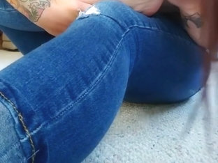 Inked Brunette In Blue Jeans Sitting On The Carpet Sucking Her Own Toe