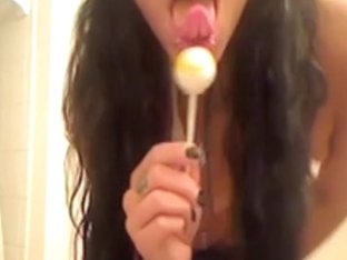 Dirty brunette masturbates with lolipop