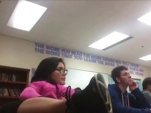 Geeky Girl Sits With Legs On School Desk