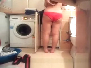 Woman Undressing In Bathroom