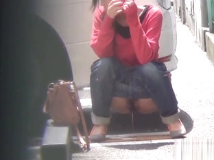 Asian whore pees behind car