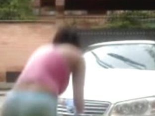 Cute Little Girls Fooling Around While Washing A Car