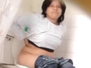 Brunette In White Shirt Sitting On The Toilet