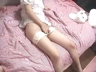 Japanese girl plays with her hairy pussy on her pink bed