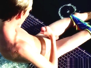 Blonde twink Tyler Thayer jerking his cock near the pool
