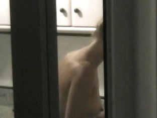 Window Shot Of A Naked Woman In The Kitchen