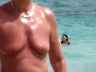 The Old Woman Is Walking Topless On The Beach