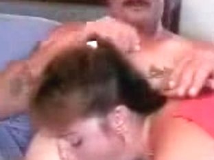 Mature woman demonstrating her tattoos and sucking skills