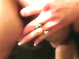 Mature blonde dominating a sexy shemale with a big strap-on