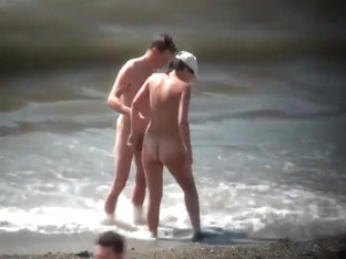 Naturists Enjoying The Wavy Sea