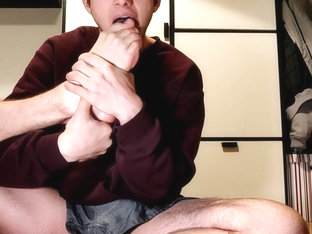 Young Boy shows off his feet and loves to suck on his toes