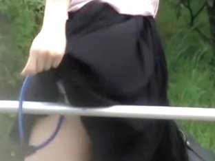 Sharking her skirt to lock her panties to the metal rail