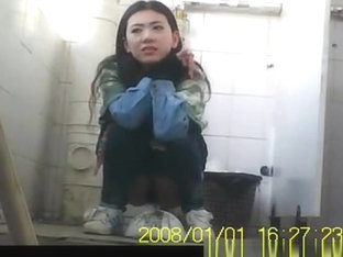 Asian girl pulls down her tight jeans to pee