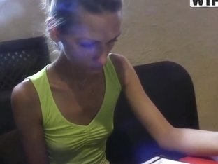 A fit brunette enjoys a smoothie and broods