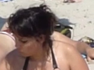 Beach voyeur 02 - A topless gril and her large boobs ally