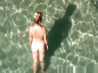 Nudist woman takes off her black bikini