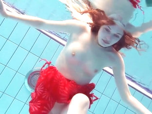 Red Dressed Teen Swimming With Her Eyes Opened