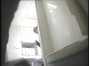 A juicy brunette caught by a spy camera pissing in a public toilet